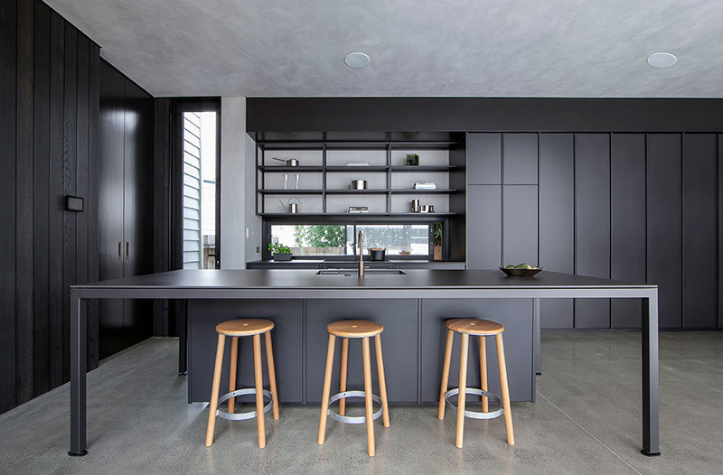a kitchen with a bar and stools